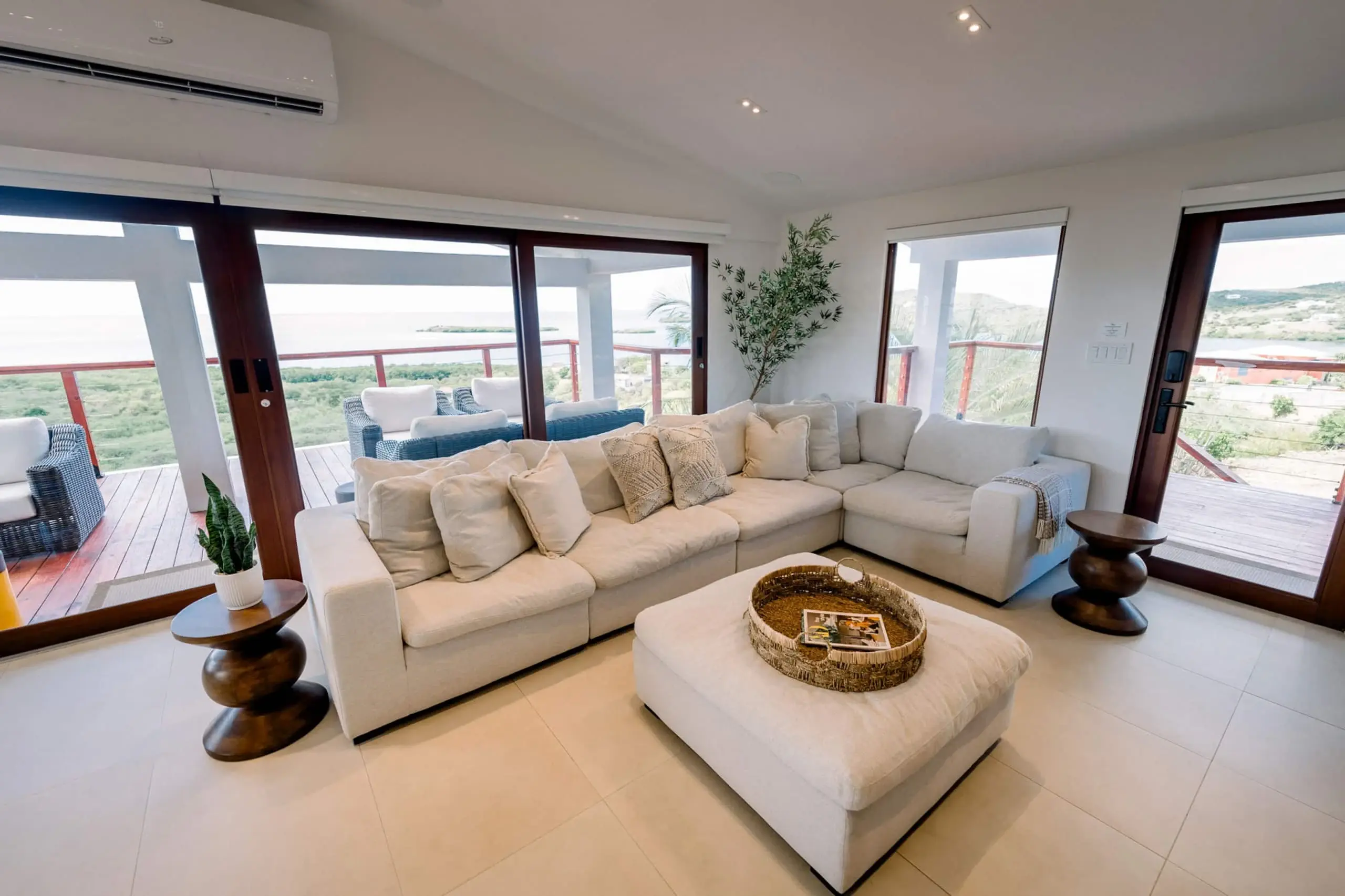 Living room with cream sectional and balcony doors