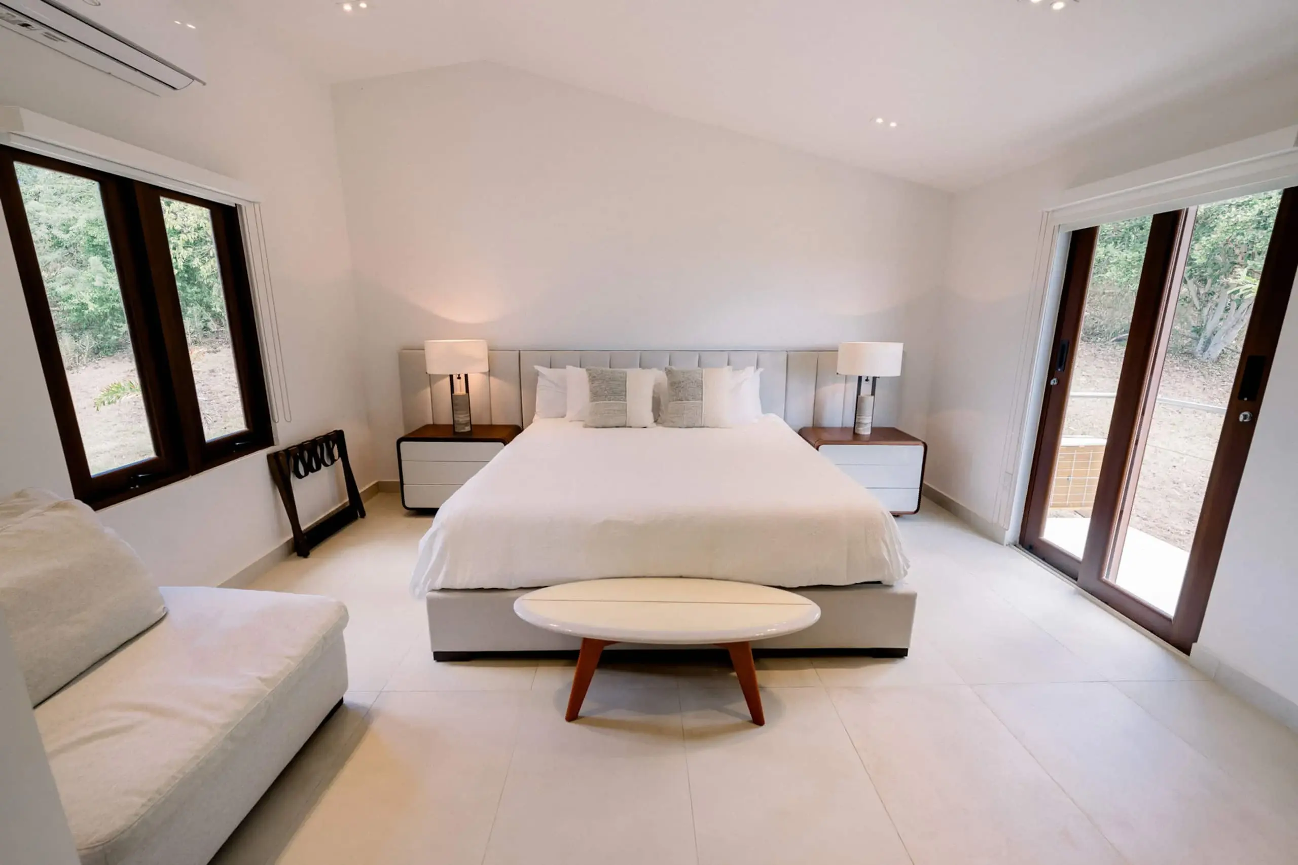 King bed framed by windows in the primary suite