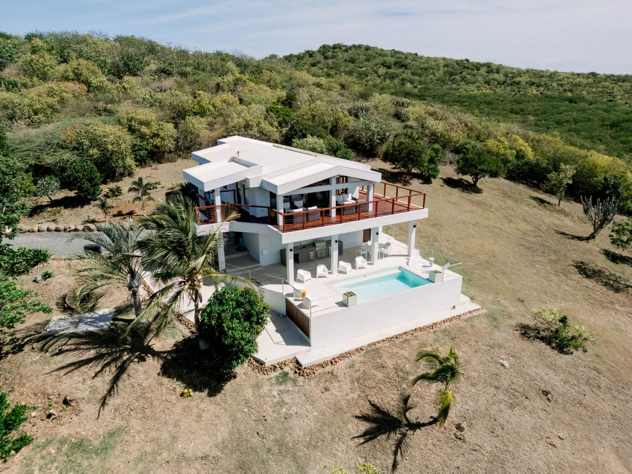 Aerial view of the two-level villa and pool